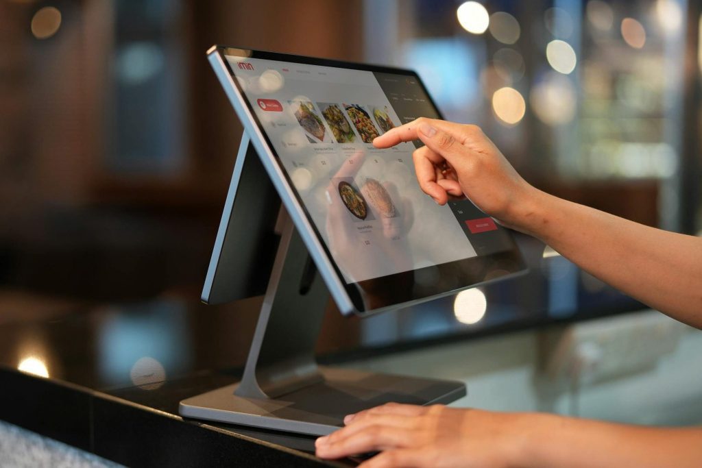 A Close-Up Shot of a Cashier Using a Point of Sale System